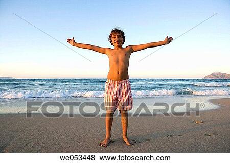 Stock Photo - Arms open, boy, beach, amusement. Fotosearch