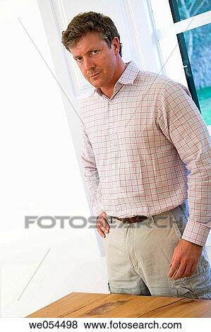 Stock Photo - at-home, Bad mood, baby boomer, angry. Fotosearch