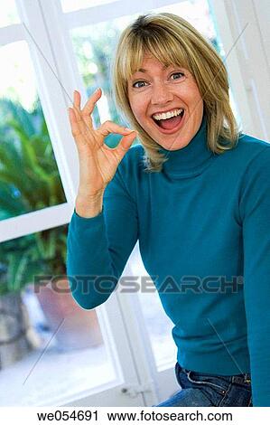 Stock Image - at-home, blond, approval. Fotosearch