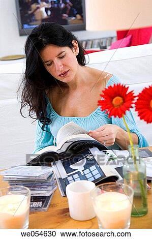 Stock Image - at-home, browsing, browse, book, 30's. Fotosearch