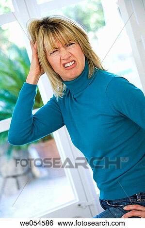 Stock Photograph - bewildered, blond, bewilderment, at-home. Fotosearch