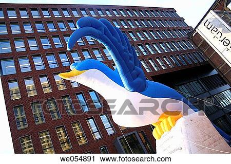 Stock Image - Big inflatable gull and office building, foundation of handicapped kids, Ijhaven, Amsterdam, Holland, Netherlands. Fotosearch