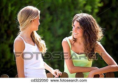 Stock Image - blond, carefree, brunette, adolescence. Fotosearch