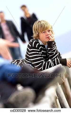 Stock Photo - blond, child, calm, boy, absorbed. Fotosearch