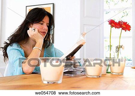 Stock Photo - book, calm, brunette, at-home. Fotosearch