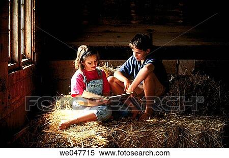 Brother and sister in barn reading a book together View Large Photo Image Stock Photography - Brother and sister in barn reading a book together. Fotosearch