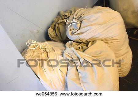 Cloth bags holding dirty laundry. View Large Photo Image Stock Photograph - Cloth bags holding dirty laundry.. Fotosearch