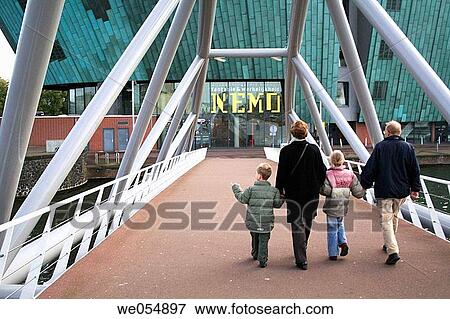 Family on the way to NeMo (National Museum for Science and Technology). Amsterdam, Oosterdok, Holland, Netherlands View Large Photo Image Stock Photo - Family on the way to NeMo (National Museum for Science and Technology). Amsterdam, Oosterdok, Holland, Netherlands. Fotosearch