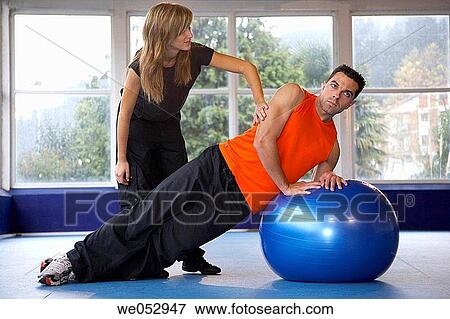 Personal trainer, exercises with fitball, gym View Large Photo Image Stock Photo - Personal trainer, exercises with fitball, gym. Fotosearch