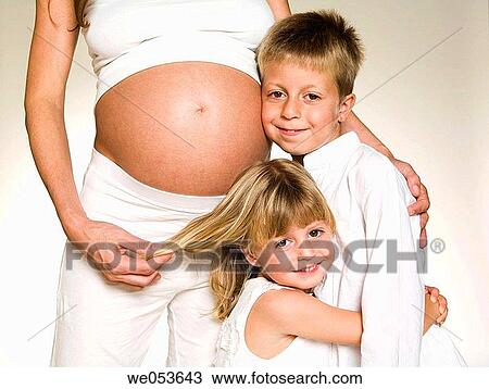 Stock Image - Pregnant Mother with her Children. Fotosearch
