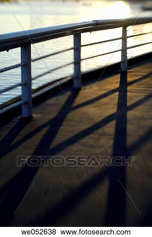 railing lookout near seawall tourist area at sunset View Large Photo Image Stock Photo - railing lookout near seawall tourist area at sunset. Fotosearch