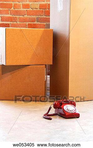 red telephone on floor with moving boxes in background View Large Photo Image Stock Photography - red telephone on floor with moving boxes in background. Fotosearch