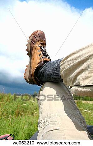 Stock Image - Relaxing hiker, man in hiking shoes. Fotosearch