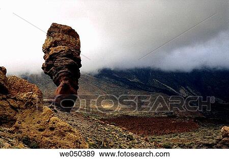 Roque Cinchado rock formation and Teide in background in fog, Teide National Park. Tenerife, Canary Islands, Spain View Large Photo Image Stock Photo - Roque Cinchado rock formation and Teide in background in fog, Teide National Park. Tenerife, Canary Islands, Spain. Fotosearch