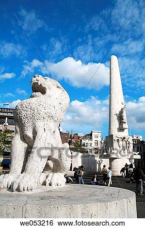 Stone lion with national monument in background, Damplein, Amsterdam, Holland, Netherlands View Large Photo Image Stock Photograph - Stone lion with national monument in background, Damplein, Amsterdam, Holland, Netherlands. Fotosearch