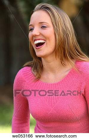 Young blonde woman in the park. Laughing off camera. View Large Photo Image Stock Photograph - Young blonde woman in the park. Laughing off camera.. Fotosearch