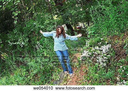 Young Indian woman posing in the woods View Large Photo Image Stock Image - Young Indian woman posing in the woods. Fotosearch