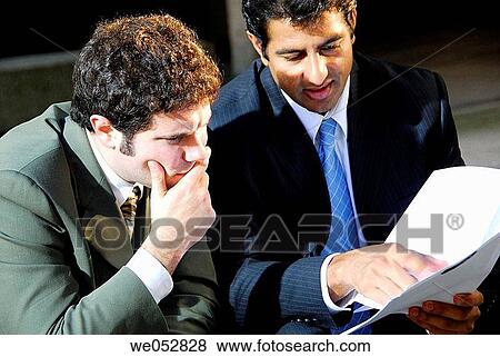 young male business men discussing documents in file folder View Large Photo Image Stock Photo - young male business men discussing documents in file folder. Fotosearch