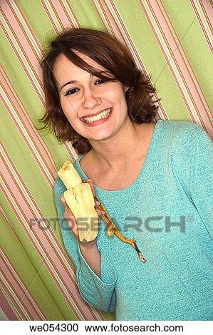 Young woman eating a banana View Large Photo Image Stock Image - Young woman eating a banana. Fotosearch
