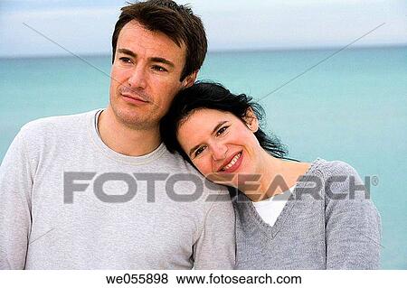 Stock Photo - absorbed, beach, autumn, affection, 30's. Fotosearch