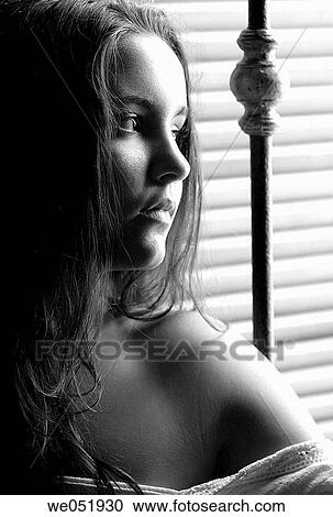 Stock Image - adolescence, brunette, black and white, beauty, absorbed. Fotosearch