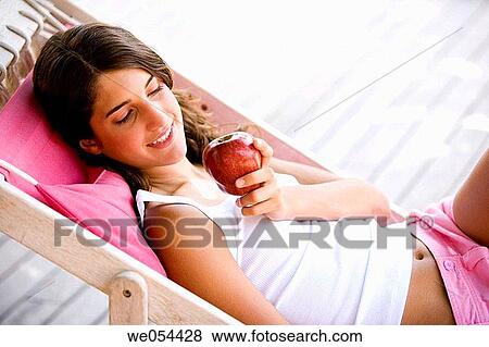 Stock Photo - adolescence, calm, brunette, apple, 20's. Fotosearch