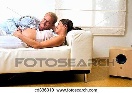 Stock Image - affection, bond, belly, at-home, 30's. Fotosearch