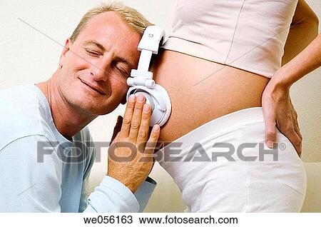 Stock Image - affection, bond, belly, at-home, 30's. Fotosearch