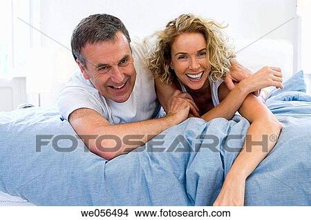 amusement, bed, baby boomer, at-home, affection View Large Photo Image Picture - amusement, bed, baby boomer, at-home, affection. Fotosearch