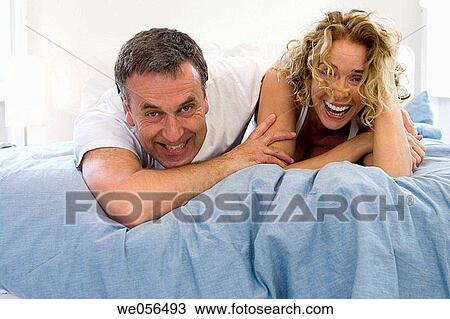 amusement, bed, baby boomer, at-home, affection View Large Photo Image Stock Image - amusement, bed, baby boomer, at-home, affection. Fotosearch