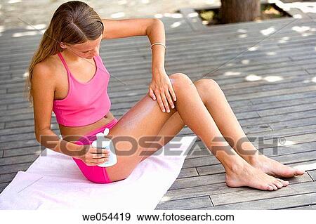 Stock Photo - apply, Body care, blond, barefoot, adolescence. Fotosearch
