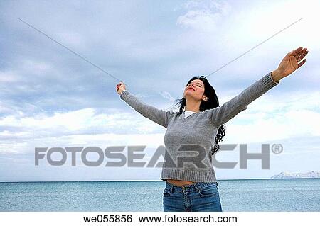 Arms open, beach, Arms raised, absorbed View Large Photo Image Stock Photograph - Arms open, beach, Arms raised, absorbed. Fotosearch