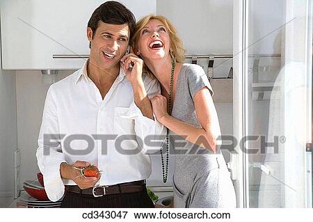 Stock Photo - at-home, cell phone, calling, amusement. Fotosearch