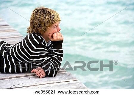 Stock Image - autumn, calm, boy, blond, absorbed. Fotosearch
