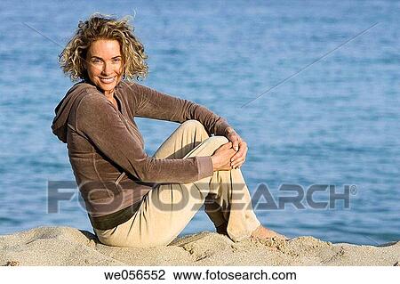 Stock Image - baby boomer, barefoot, beach, break, break-time. Fotosearch