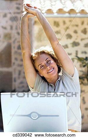 Stock Image - baby boomer, blond, break, break-time. Fotosearch