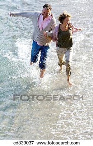 Stock Photo - baby boomer, bond, beach, barefoot, activity. Fotosearch