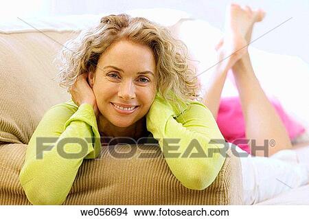 Picture - baby boomer, calm, barefoot, at-home. Fotosearch