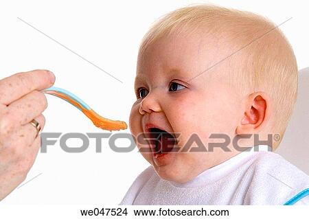 Baby fed with a spoon View Large Photo Image Picture - Baby fed with a spoon. Fotosearch