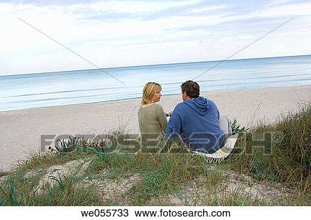 Stock Image - back view, beach, calm. Fotosearch