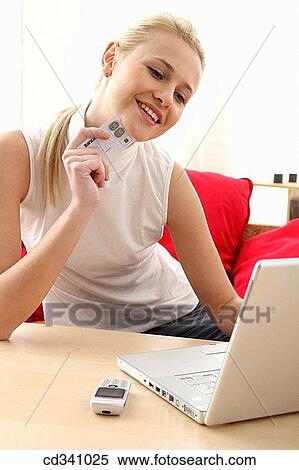 Bank card, cell phone, blond, at-home View Large Photo Image Stock Photography - Bank card, cell phone, blond, at-home. Fotosearch