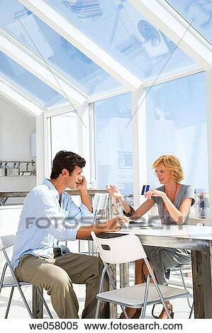 Stock Photography - Bank card, cell phone, calling, at-home. Fotosearch