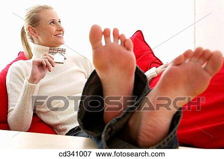 Stock Photo - barefoot, chilling out, blond, at-home. Fotosearch