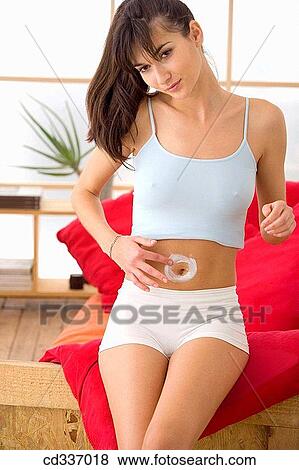 Stock Photo - belly, brunette, Body care, apply. Fotosearch