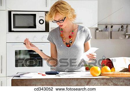 Stock Image - bill, check, calculator, at-home. Fotosearch