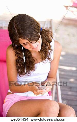 brunette, cell phone, adolescence View Large Photo Image Picture - brunette, cell phone, adolescence. Fotosearch