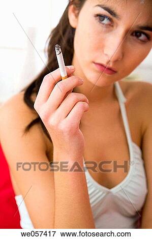 brunette, cigarette, absorbed View Large Photo Image Stock Photo - brunette, cigarette, absorbed. Fotosearch