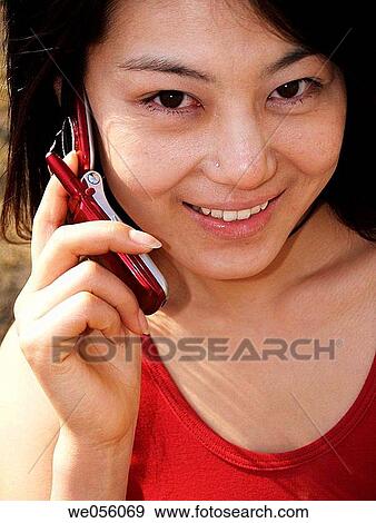 Stock Photo - chinese girl talking on the phone. Fotosearch