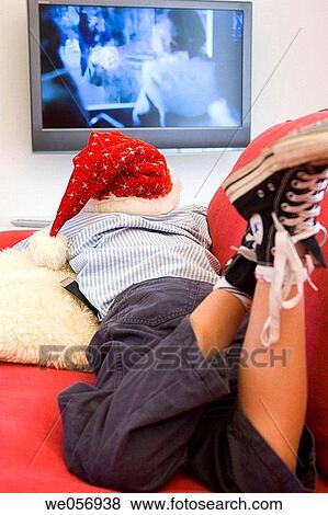 Stock Photo - Christmas, at-home, child, boy, back view, addiction. Fotosearch