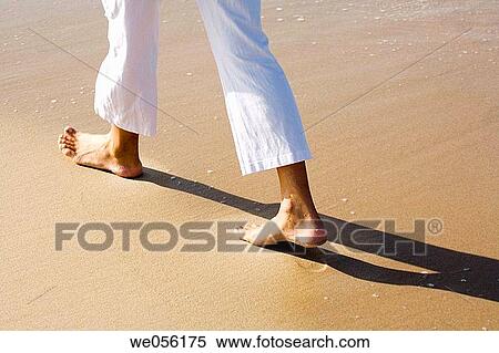 Stock Photography - Detail of Feet Walking on the Sea Shore. Fotosearch